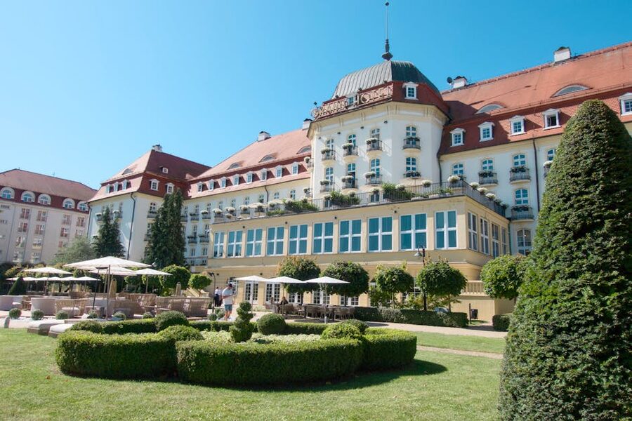 A grand historic hotel exterior with manicured gardens