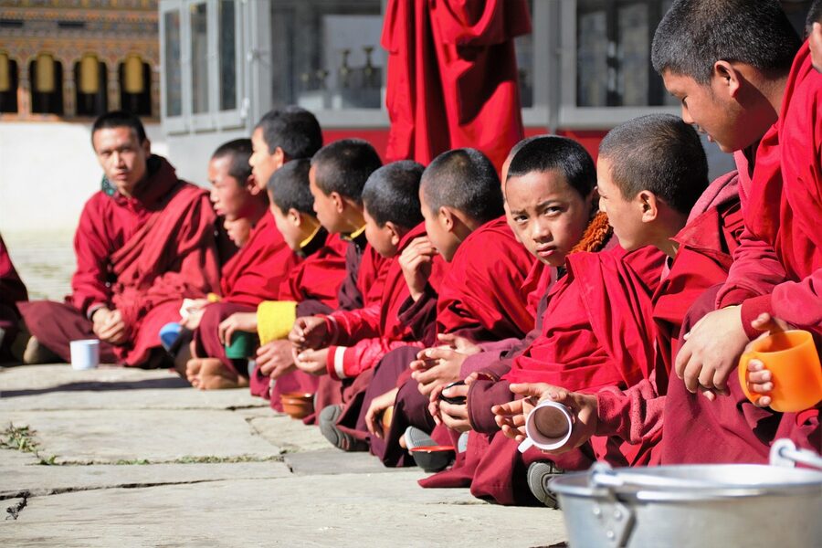 Bhutanese monks at tea ceremony inside a Himalayan monastery
