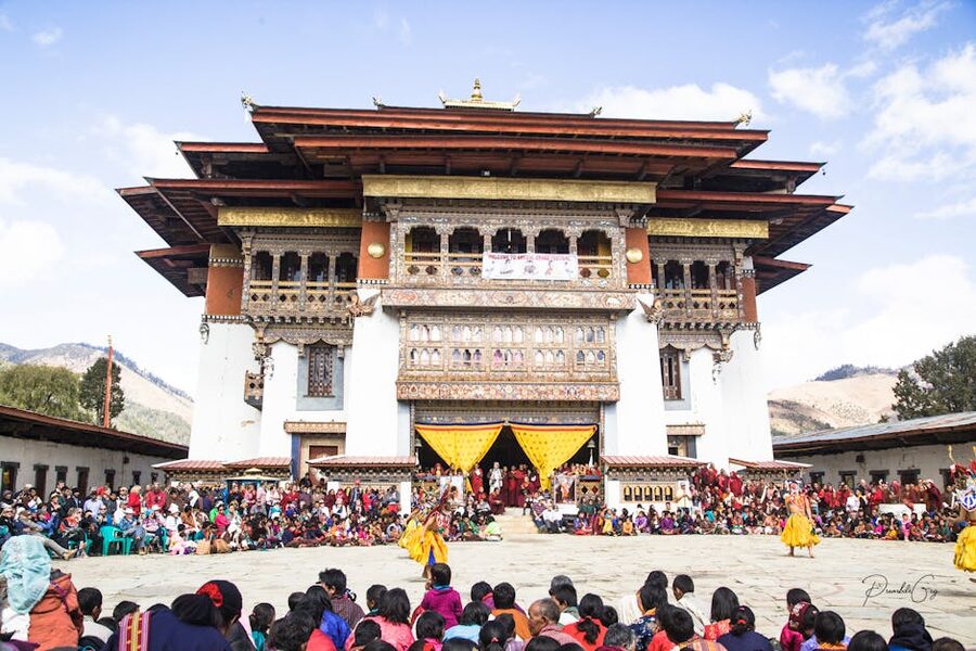 Punakha Dzong with traditional Bhutanese ceremony in foreground