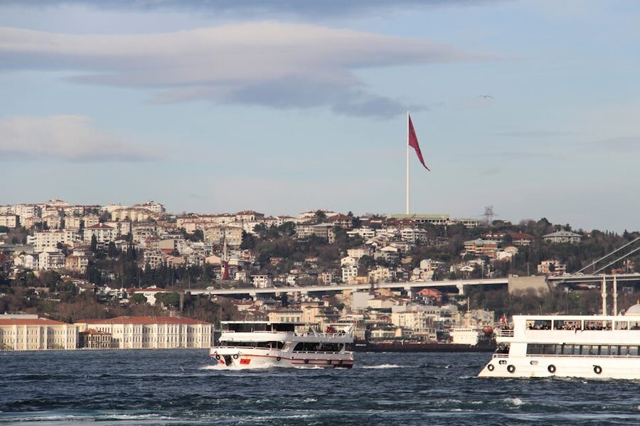 Small boats on the Bosphorus with a Turkish flag flying