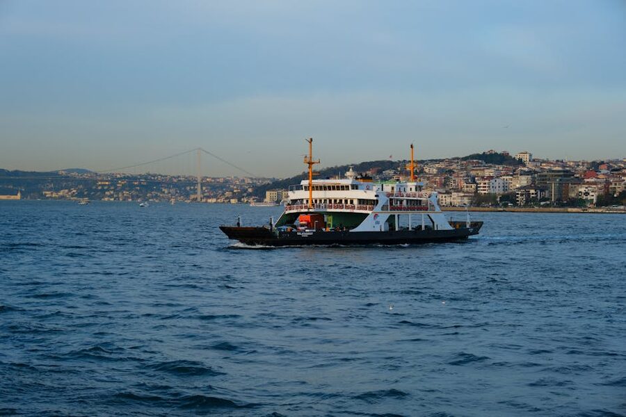 Public ferry crossing the Bosphorus with the Istanbul cityscape and bridge in the background