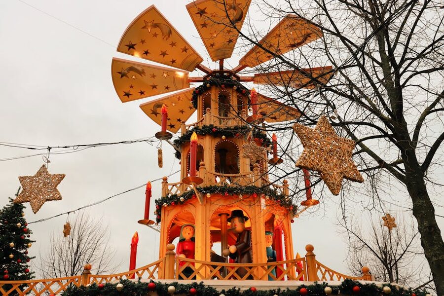 Wooden Christmas pyramid with figurines and candles at a German Christmas market
