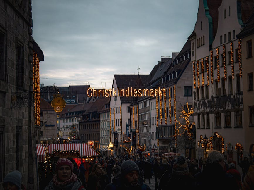 Nuremberg Christkindlesmarkt evening view with red and white striped stall awnings