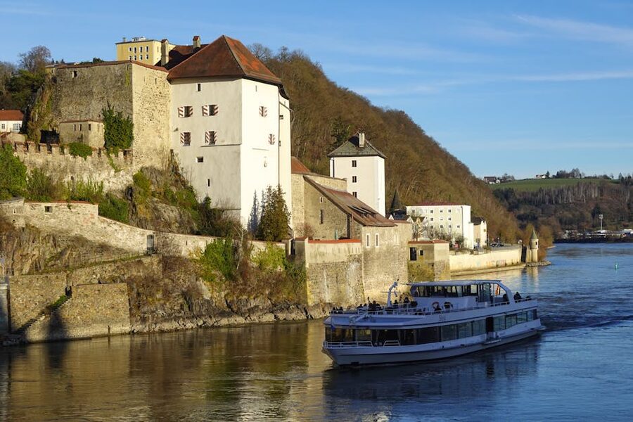 River cruise ship moored at Passau on the Danube with castle in background