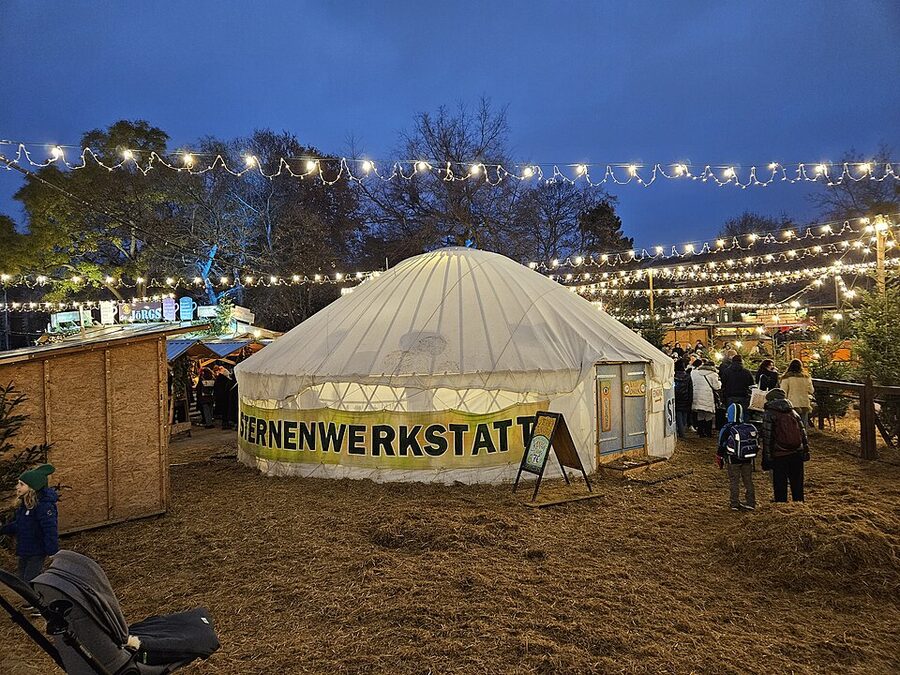 Vienna Karlsplatz Christmas market yurt at night with snow on the roof