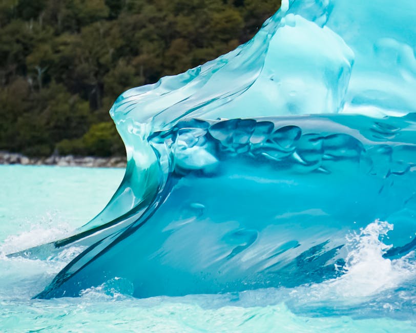 Close-up of vivid blue iceberg in clear glacier water