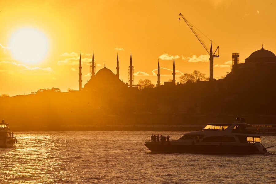 Silhouette of Istanbul mosques at sunset over the water
