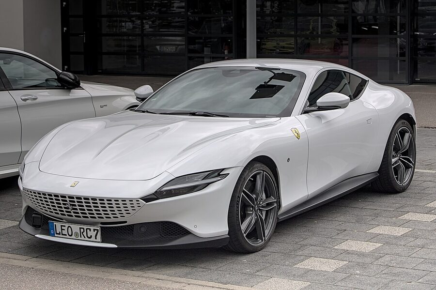 A Ferrari Roma sports car parked on a road in Italy