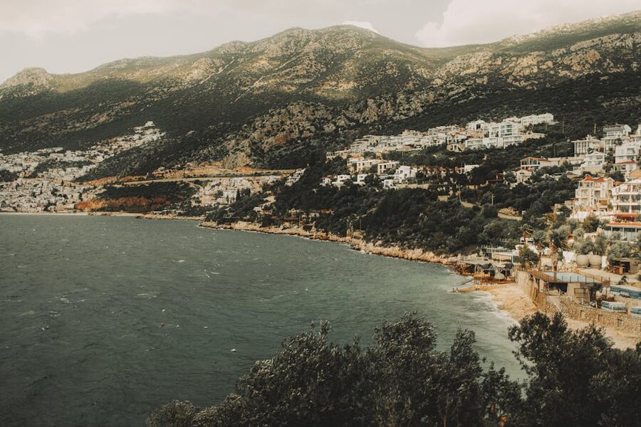 Mediterranean coastal town set against a mountain backdrop in Kalkan