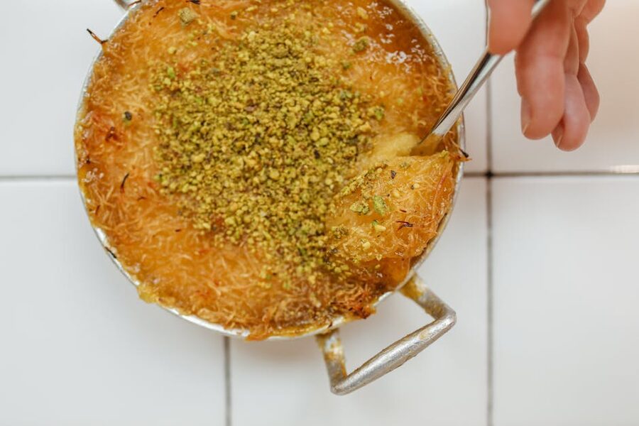 Knafeh dessert topped with crushed pistachios