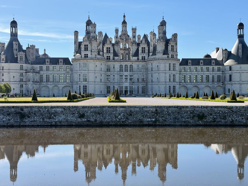 Chateau de Chambord mirrored in tranquil water on a clear day