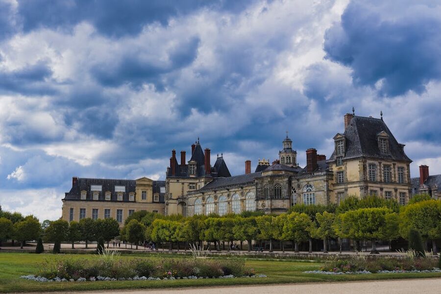 Chateau de Fontainebleau under a dramatic cloudy sky