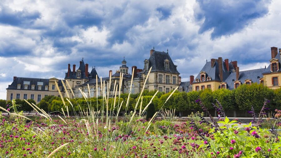 Gardens at Chateau de Fontainebleau with a path running between flowerbeds