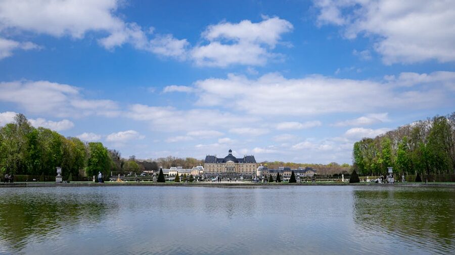 The main facade of Chateau de Vaux-le-Vicomte reflected in the moat