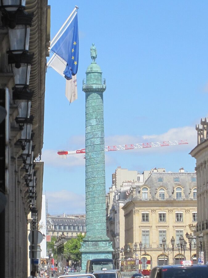 The Vendome Column rising tall against the buildings of Place Vendome