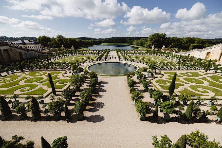 Aerial view of the geometric gardens of Versailles in summer