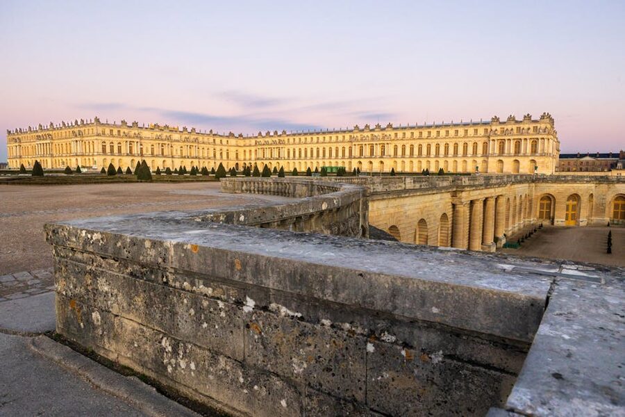 The Palace of Versailles at sunset, with the western light on the central facade