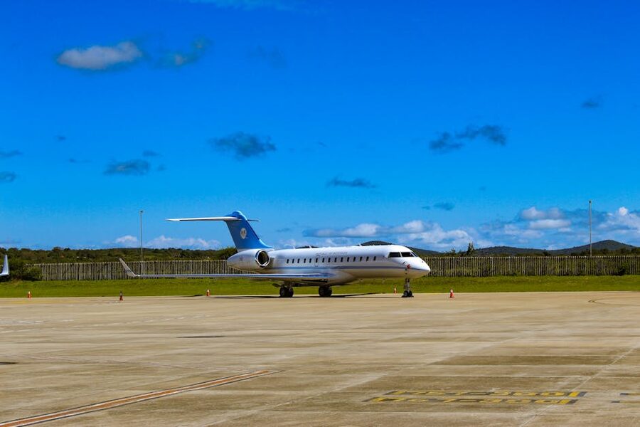 Private jet on the tarmac at an airport under blue sky