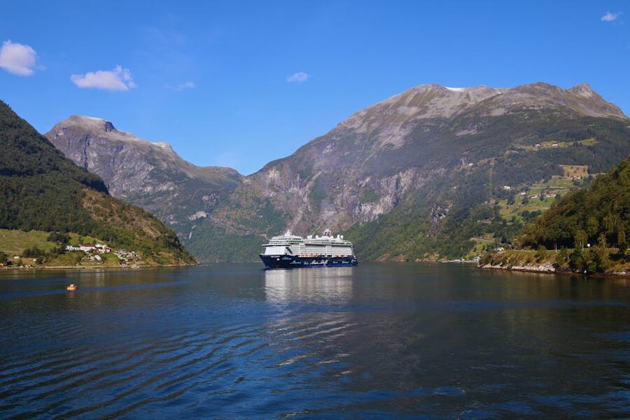 A cruise ship in Geiranger Fjord, Norway, with steep mountain walls behind