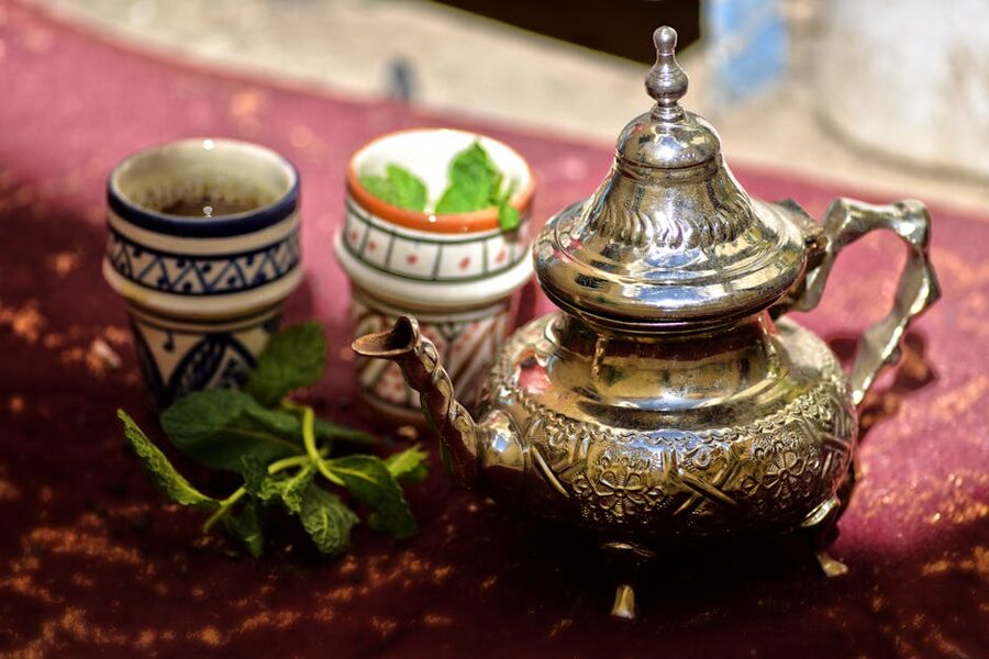 Moroccan mint tea poured from height into small glasses