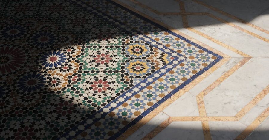 Detail of Moroccan zellige mosaic tilework on a courtyard floor