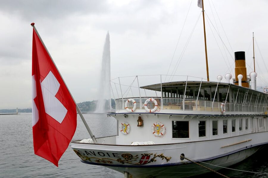 Historic CGN paddle steamer with Swiss flag on Lake Geneva