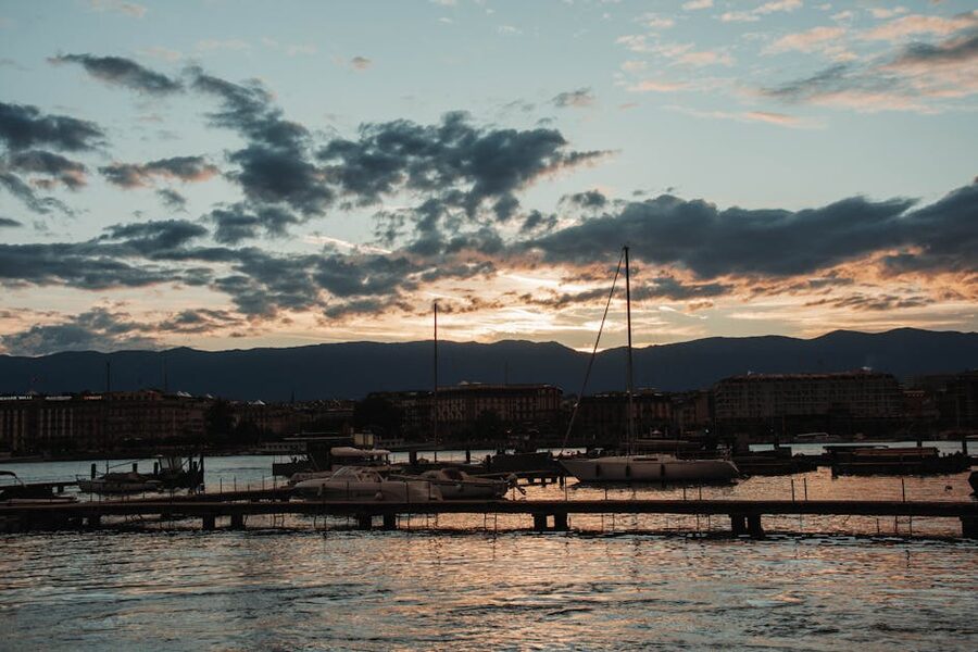 Yachts moored in Lake Geneva marina at sunset