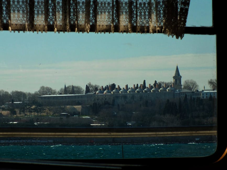 Distant view of Topkapi Palace seen through a latticed window in Istanbul