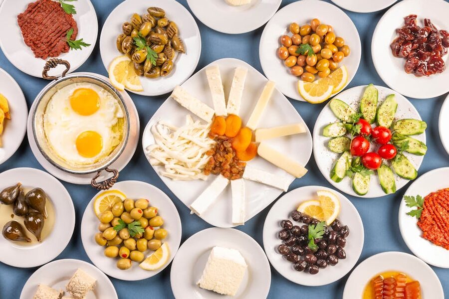 Traditional Turkish breakfast spread with cheeses, olives, eggs and tea