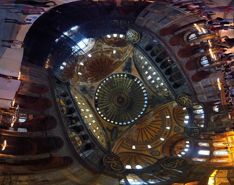 Panoramic interior view of Hagia Sophia showing the central dome and chandeliers